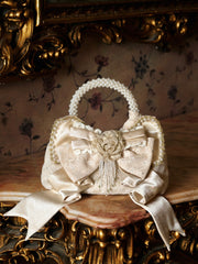 Elegant Pearl Handle Cream Handbag with Satin Bow Accent