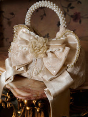 Elegant Pearl Handle Cream Handbag with Satin Bow Accent