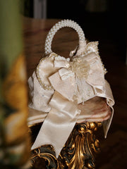 Elegant Pearl Handle Cream Handbag with Satin Bow Accent